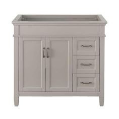 a white bathroom vanity with drawers and doors