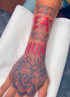 a person's hand with a tattoo on it that says eat hunt and an image of a tiger