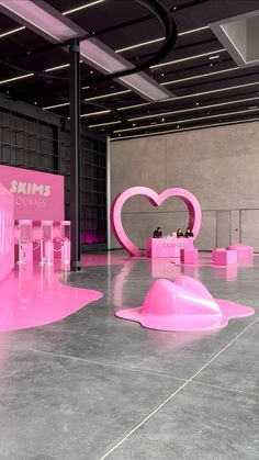 a room with pink furniture and large letters on the walls that spell i love you