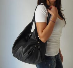 "A black leather shoulder bag with a unique design made from soft Italian pebbled leather named DeLuna. DeLuna is a large hobo bag designed for women who love to carry slouchy handbags. Handcrafted from soft cowhide leather and paired with nickel-tone hardware you will find inside one main compartment with a large zip pocket and 3 more slip pockets. This sling bag has a wide top opening and it is secured with a top zip. We use the best YKK zippers for our bags. Featured in this listing in soft b Slouchy Handbags, Slouchy Hobo Bag, Large Hobo Bag, Black Handbag, Hobo Bags, Black Leather Bags, Black Shoulder Bag, Bag For Women, Black Handbags