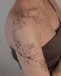 a woman with a flower tattoo on her arm