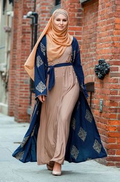 Channel you inner Arabian Nights princess with Marrakech Damask Open Front Abaya! Made premium polyester fabric and gold damask detailing and scallop paneling. This abaya is not see-through making it perfect for all occasions! You can dress it up or down with a pair of jeans. Paired with our Camel Chiffon Hijab for a complete look! Open Front Belt Included Color: Navy Blue Model is 5'7" wearing size S Orange Satin Skirt, Arabian Fashion, Elegant Abayas, Blue Abaya, Fantasy Outfits, Ancient Armor, Chiffon Hijab, Orange Satin, Swimsuits Outfits