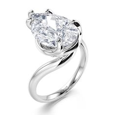 a pear shaped diamond ring on a white background