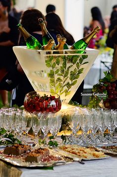 a table topped with lots of glasses filled with wine and food next to each other