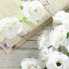 some white flowers and a book on a table