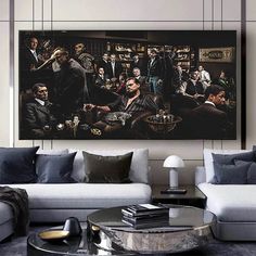 a living room filled with furniture and a large painting on the wall above it's coffee table