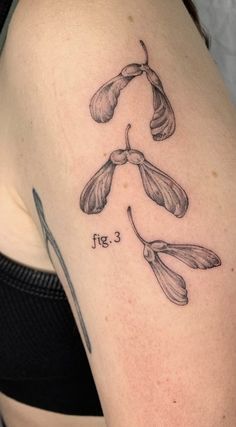 a woman's arm with three flowers on it and the word love written in cursive writing