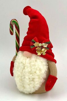 a stuffed santa claus hat with candy cane