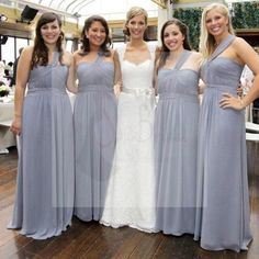 four bridesmaids in grey dresses posing for the camera