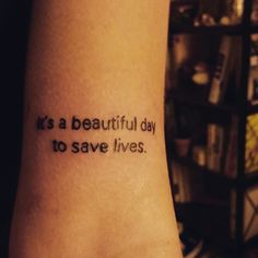 a tattoo saying it is a beautiful day to save lives on someone's arm