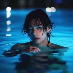 a woman is in the water with her hand on her chest