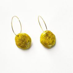 Lightweight earrings made by recycling paper from a sales catalogue.  The earrings have been painted yellow with gold sparkles on both sides, and have new stainless steel gold plated hoops. They are 4cm in length and 2cm in width.  Smart, funky and a great conversation piece! Disclaimer: Because they are 100% handmade, paper earrings may have small imperfections. CARING FOR YOUR EARRINGS: -These earrings have been sealed and so should be water resistant. But please don't wear them whilst swimming or in the shower. -Similar to any type of jewellery, the earrings will break if bent or not handled with care. RETURNS & EXCHANGES: Returns and exchanges are not possible due to hygiene. However, if there is an issue with your order, please let me know. I'm committed to your satisfaction. Thank yo Handmade Yellow Small Hoop Earrings, Handmade Small Hoop Yellow Earrings, Yellow Small Hoop Earrings For Gift, Yellow Small Hoop Earrings As Gift, Handmade Small Yellow Hoop Earrings, Yellow Drop Hoop Earrings As Gift, Yellow Hoop Earrings For Everyday, Single Yellow Small Hoop Earring, Everyday Yellow Hoop Earrings