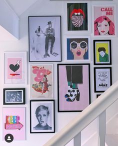 a staircase with many framed pictures on the wall