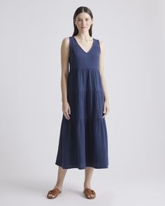 The ultimate slip on and step out style, this easy-to-wear dress still packs a fashionable punch. Made of breezy, lightweight organic cotton gauze, it features a v-neck in the front and back and flowy tiered bodice. Slide into a pair of sandals and top with a few pieces of jewelry and you’ve got a full look.  | Quince | Women's Gauze Tiered Maxi Dress in Indigo Blue, Size Medium, Organic Cotton Quince Blue, Comfy Summer Dresses, Dresses Quince, Gauze Maxi Dress, Wide Leg Linen Pants, Quince Dresses, Tiered Maxi Dress, Organic Fabrics, Maxi Dress Blue