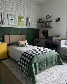 a bed room with a neatly made bed next to a desk and dressers in front of a window