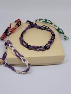 Dyed hemp cord knotted by hand and tied in an interwoven, Celtic knot style pattern. Each bracelet is a different color combination and different sizes. Please make your selection carefully before you check out. These bracelets are not adjustable. Wood bead and loop closure. Metal free, allergy friendly! Ready to ship! All sales final. Casual Macrame Bracelets With Waxed Cord, Casual Hand Wrapped Braided Bracelets In Waxed Cord, Handmade Casual Braided Bracelets With Waxed Cord, Casual Macrame Friendship Bracelets, Multicolor Macrame Friendship Bracelets With Waxed Cord, Multicolor Macrame Friendship Bracelets, Casual Macrame Braided Bracelets As Gift, Casual Macrame Braided Bracelets For Gift, Casual Purple Braided Bracelet With Sliding Knot