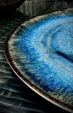 a blue and white plate sitting on top of a table