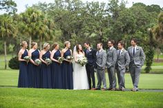 a group of people standing next to each other on top of a lush green field