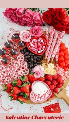 valentine's day dessert platter with strawberries, chocolates and flowers