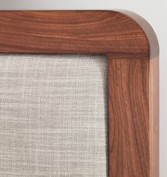 a close up view of a wooden frame with fabric on the bottom and side panels