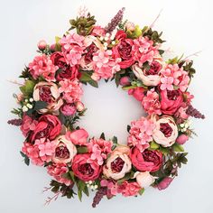 a floral wreath with pink and red flowers