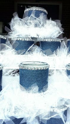 several blue buckets are stacked on top of each other with white netting around them