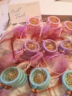 there are many different items in the box on this table, including beads and feathers