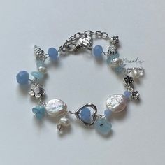 "Handmade Pearl bracelet ✿ Made with glass beads, glass crystal beads, freshwater pearls, and metal accents ✿ Silver, powder blue, pearliest white, and iridescent clear ✿ 7\" plus 1.5\" of extension chain. If you'd like a shorter or longer length, select your preferred length. Some beads may be added or removed." Metallic Beads Bracelet, Cute Blue Bracelet, Silver And Blue Bracelet, Beaded Bracelets Silver, Blue Charm Bracelet, Wire Beaded Bracelets, Bracelets Diy Beads, Cute Charm Bracelets, Blue Beaded Jewelry