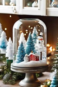 a snow globe with christmas trees in the background