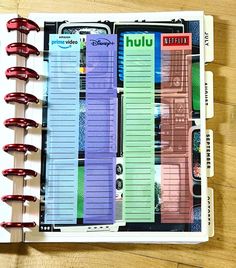 an open planner book sitting on top of a wooden table