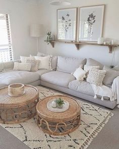 a living room filled with white furniture and lots of pillows on top of the couch