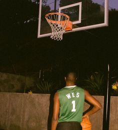 a basketball player is standing in front of the hoop