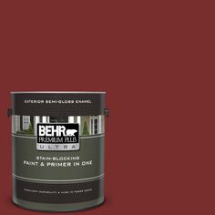 a can of behr premium plus ultra paint and primer in one on a green background