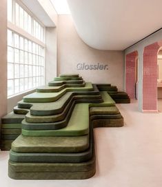 an empty room with green and pink benches