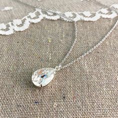 "Heatherly Designs simple pendant necklace made using a genuine teardrop Swarovski® crystal in colorless 'Crystal'. Necklace chain, setting and findings are plated brass. ●Nickel free ●Length (adjustable): 17\" - 19\" or 43.18 - 48.26cm ●Pendant Size: 14x10mm ●Swarovski® crystal color(s): Crystal ●Matching Earrings: http://etsy.me/1KcIUID ●Matching Bracelet: http://etsy.me/2a6MZi9 ●Arrives in our signature Heatherly gift box. Handmade with ❤ by Heather ● ● ● ● ● ● ● ● ● ● ● ● ● ● ● ● ● ● ● ● ● ● Teardrop Crystal Drop Necklace For Anniversary, Crystal Teardrop Drop Necklace For Anniversary, Crystal Teardrop Necklace For Anniversary, White Crystal Teardrop Drop Necklace, Teardrop Crystal Necklace For Gift, Teardrop Crystal Necklace Gift, Crystal Teardrop Pendant Necklace Gift, Pear-shaped Crystal Drop Necklace Gift, Gift Teardrop Crystal Necklace