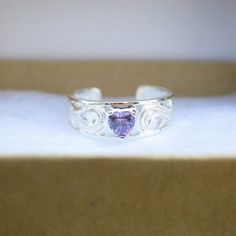 Hawaiian 925K Sterling Silver Purple Heart CZ Toe Ring All toe ring comes with a gift box. Weight: 1.5g Quantity: 1 Toe Ring Hawaiian Design, Heart Purple, Hawaiian Designs, Toe Ring, Purple Stones, Purple Heart, Toe Rings, Hawaii, Gift Box