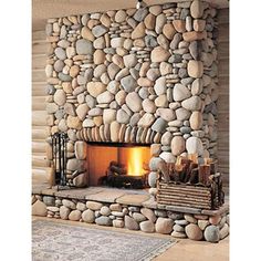 a stone fireplace in a log cabin with logs and firewood on the mantles