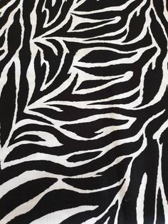 black and white zebra print fabric with very thin lines in the center, as well as an interesting pattern