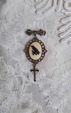 Encased in a Victorian antiqued bronze toned setting, with rich vintage color our Raven Cameo Brooch measures 3 inches in length. (Cameo 25x18mm) Every item in our shop is handmade, and created with loving care.   Please note: Any glare on the cameo occurs from the photo and is not a blemish on the piece.  For your timeless style! Your treasures come tucked into a lovely organza bag. If your order is being sent directly to a gift recipient, we are delighted to take part in your thoughtfulness, a Vintage Brooch With Antique Finish, Vintage Bronze Brass Brooches, Victorian Bronze Brooches For Gift, Bronze Victorian Brooches For Gifts, Antique Bronze Brooches For Gift, Vintage Antique Gold Brooches For Gift, Antique Gold Brass Brooch For Gift, Vintage Brown Brooches For Gifts, Crow Witch