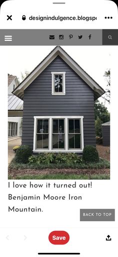 a house that has been painted gray and is being advertised on the app for sale