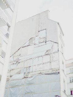 an old building is covered with tarp and scaffolding