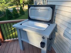 an ice chest sitting on top of a wooden deck