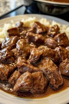 a white plate topped with meat and gravy