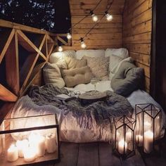 a bed sitting on top of a wooden floor covered in lights