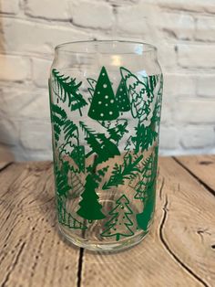 a clear glass with green christmas trees on it