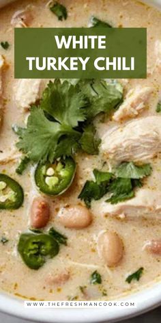 white turkey chili soup in a bowl with cilantro and green peppers on top