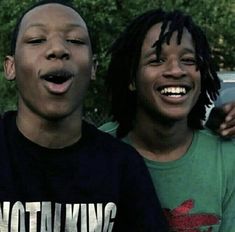 two young men standing next to each other with their mouths open in front of them