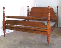 a wooden bed frame sitting in a bedroom next to a wall with a window behind it