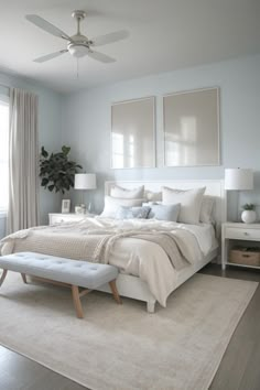 a bedroom with a large bed and white furniture