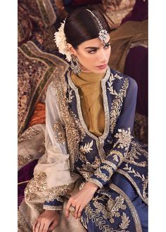 Wedding Party Outfit in Blue Color emblazoned with embroidery, tilla, dabka work is added to stores to adorn your wardrobe with wedding party wear collection. Frock This lavish attire is highlighting its grace with blue silver embroidered tilla, dabka, kora front and back of shirt. This elegant shirt is embellished with copper gold and pink embroidered work of threads. Sleeves and front, back of shirt is embellished with beautiful tilla, kora work. Shirt is in open style. Trouser: This wedding p Blue Dabka Dupatta For Reception, Silver Dress With Zari Work For Eid, Blue Dabka Dress For Reception, Silver Eid Dress With Zari Work, Unstitched Blue Lehenga With Dabka Detailing, Blue Dabka Lehenga Unstitched, Blue Dabka Lehenga For Reception, Blue Dabka Salwar Kameez For Wedding, Blue Anarkali Lehenga With Dabka Detailing